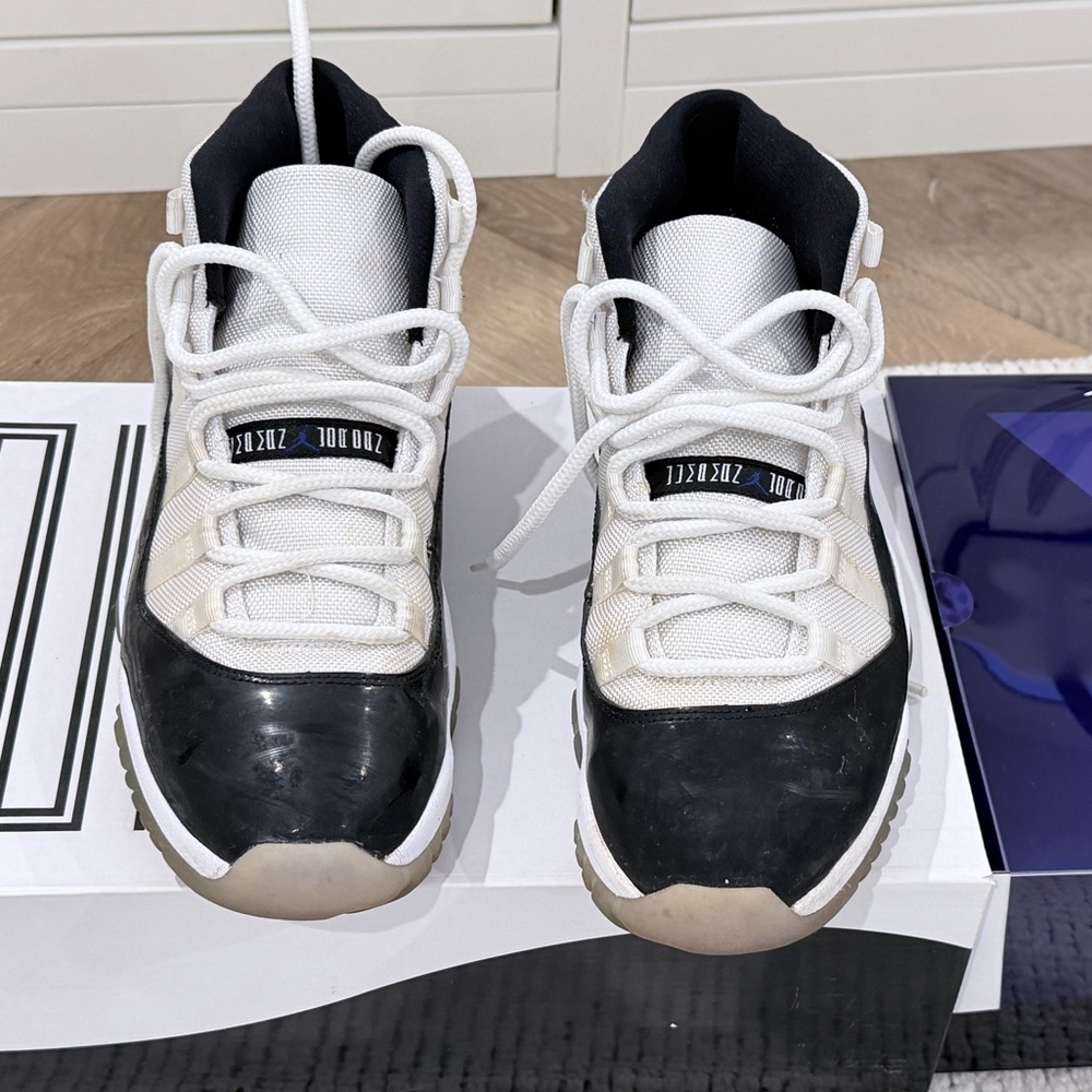 Air Jordan 11 Retro Concord 2011; dark concord, white, and black.